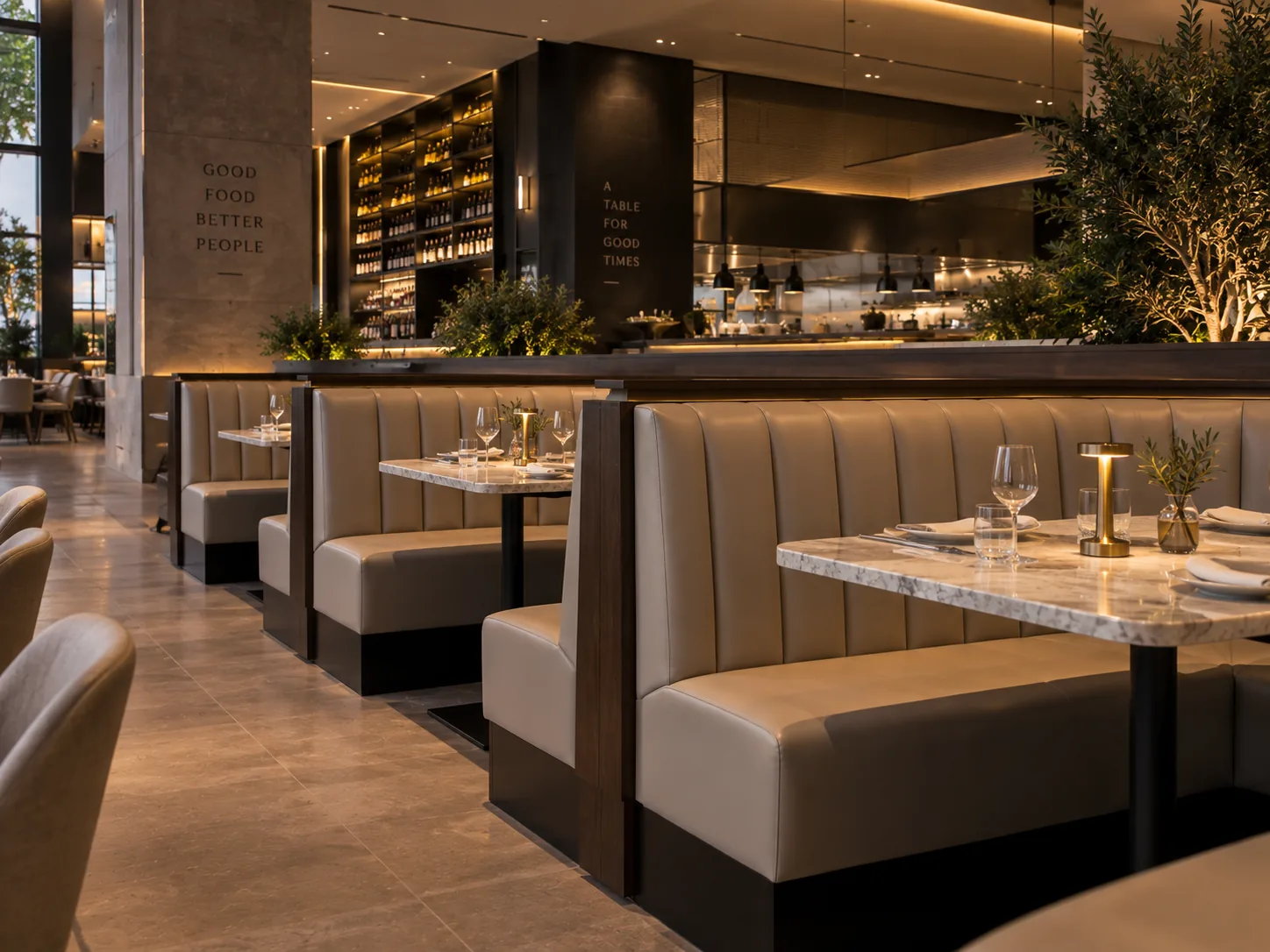 Channel-back booths in beige leather with marble tables in a hotel restaurant