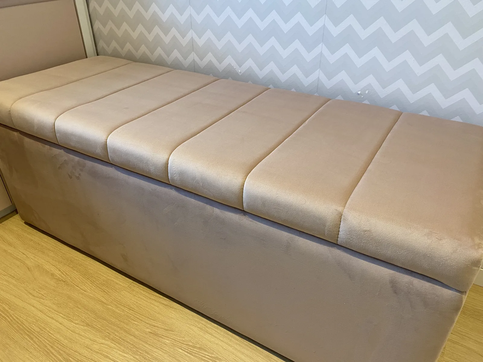 Recamier de canaletas em veludo rosé ao pé da cama
